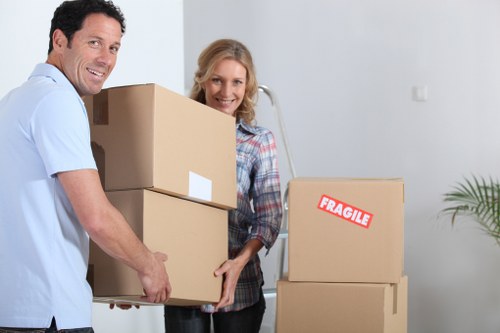 Professional movers carrying household items through a Tooting flat entrance